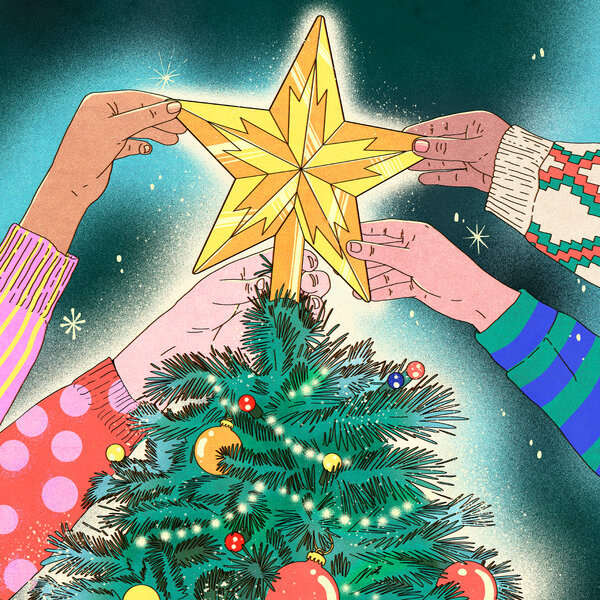 Hands placing golden star on top of decorated Christmas tree with ornaments