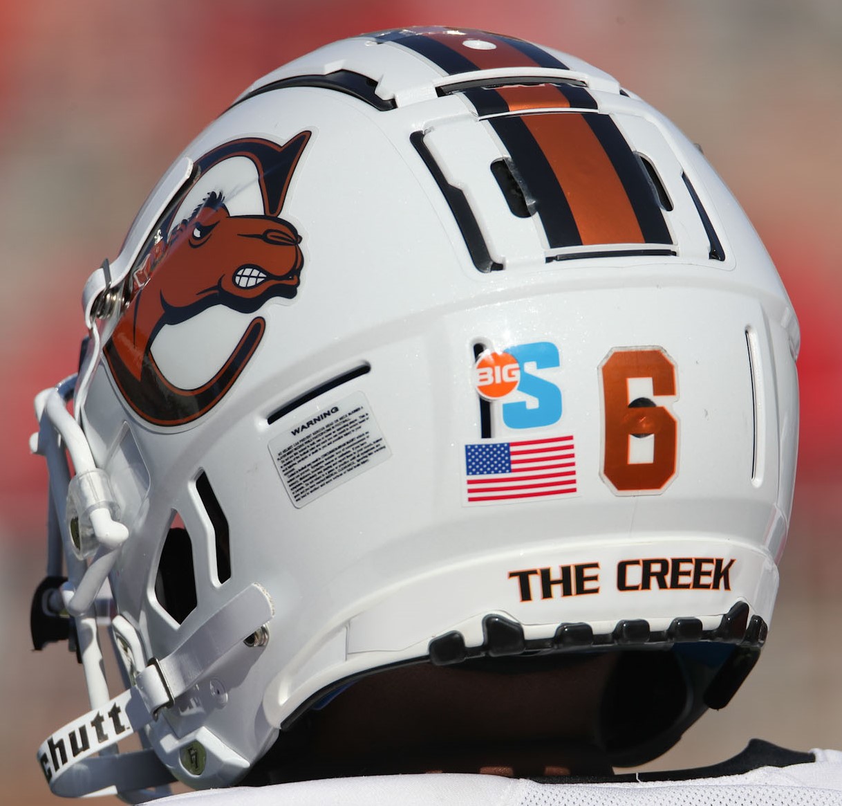 Back and side view of a white football helmet with orange black stripes and number 6
