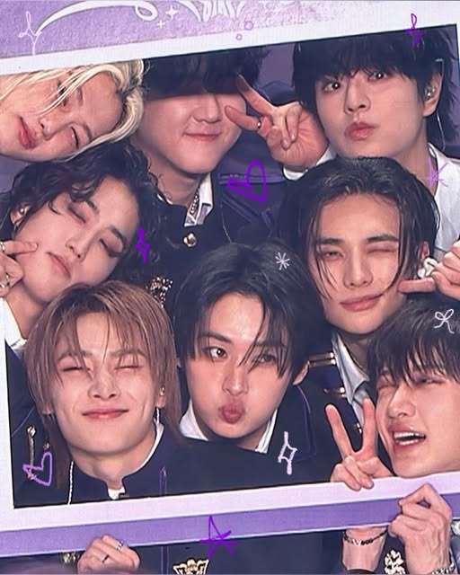 Eight young men posing playfully with peace signs in a purple-framed group photo