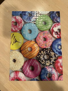 Colorful donuts with various frostings and sprinkles arranged together