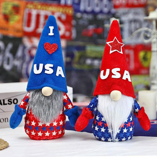 Two red, white, and blue USA-themed gnome dolls with tall hats and long beards
