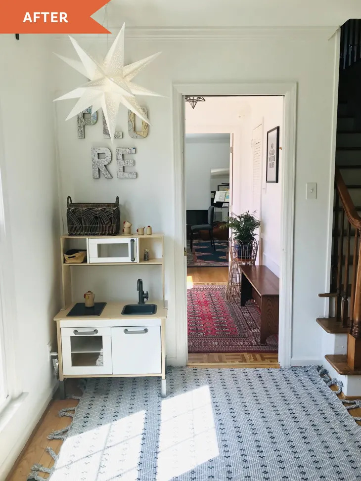 White star pendant light hanging above entryway with toy kitchen and geometric floor mat