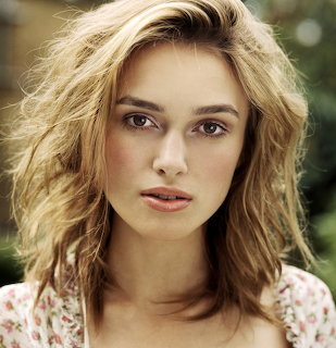 Close-up portrait of Keira Knightley with tousled hair and a floral top