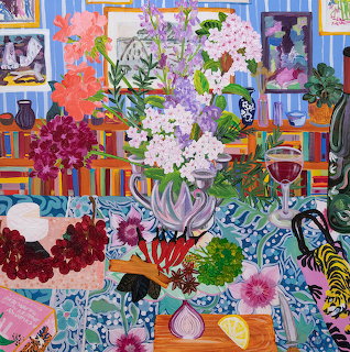 Colorful painting of flowers in vase on table with patterned cloths, fruit, and decorative items in bright interior
