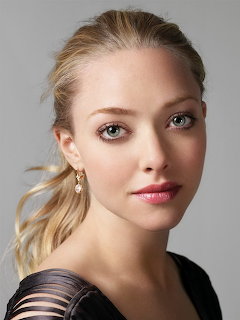 Portrait of Amanda Seyfried with blonde hair and blue eyes looking at camera