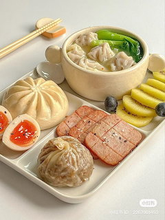 Tray of Korean-style food with dumplings, noodles, sliced meat, pickles, and soft-boiled eggs