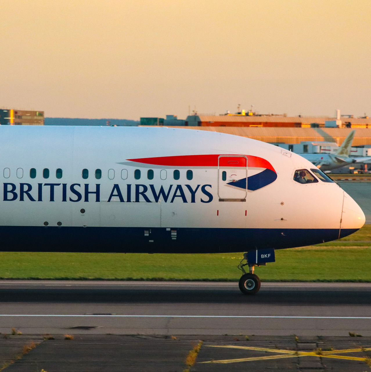 British Airways Boeing 787 Dreamliner on airport runway at sunset