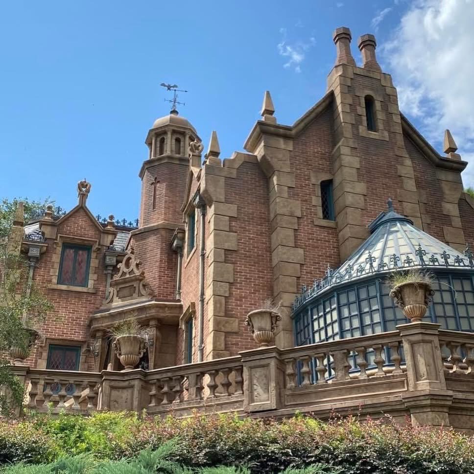Gothic brick mansion with towers and turrets at Disney theme park