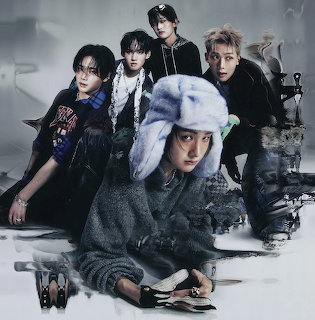 Stylized portrait of four young men in dark outfits posing against a smoky gray background