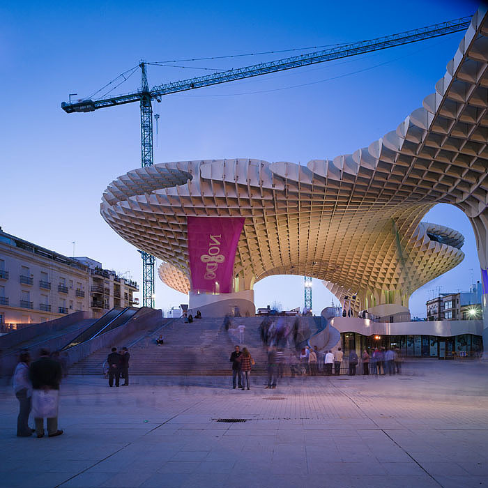 Metropol Parasol wooden structure in Seville at twilight with people in plaza