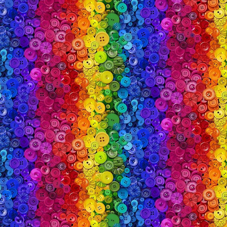 Vibrant rainbow gradient pattern made of hundreds of colorful sewing buttons arranged in vertical stripes
