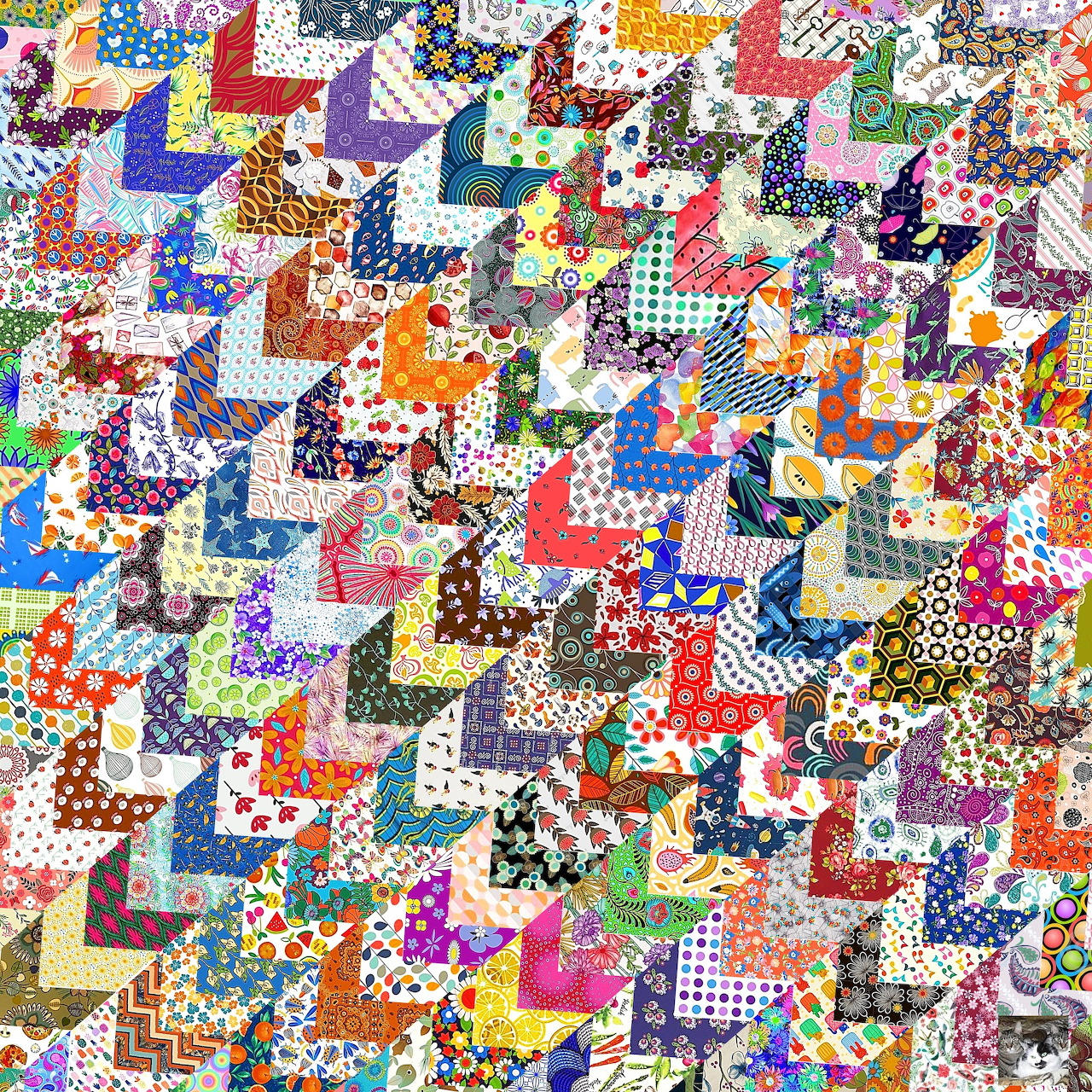 Dense colorful patchwork quilt with varied fabric patterns and geometric shapes in bright rainbow colors