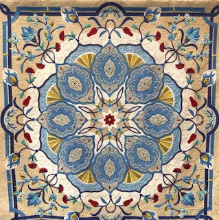 Ornate blue and red floral tile pattern with symmetrical mandala design