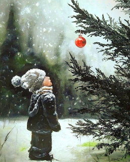 Child in winter coat standing in snowy forest reaching for red ornament on pine tree