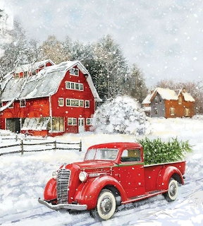 Red vintage truck with Christmas tree in back near a red barn in a snowy winter landscape