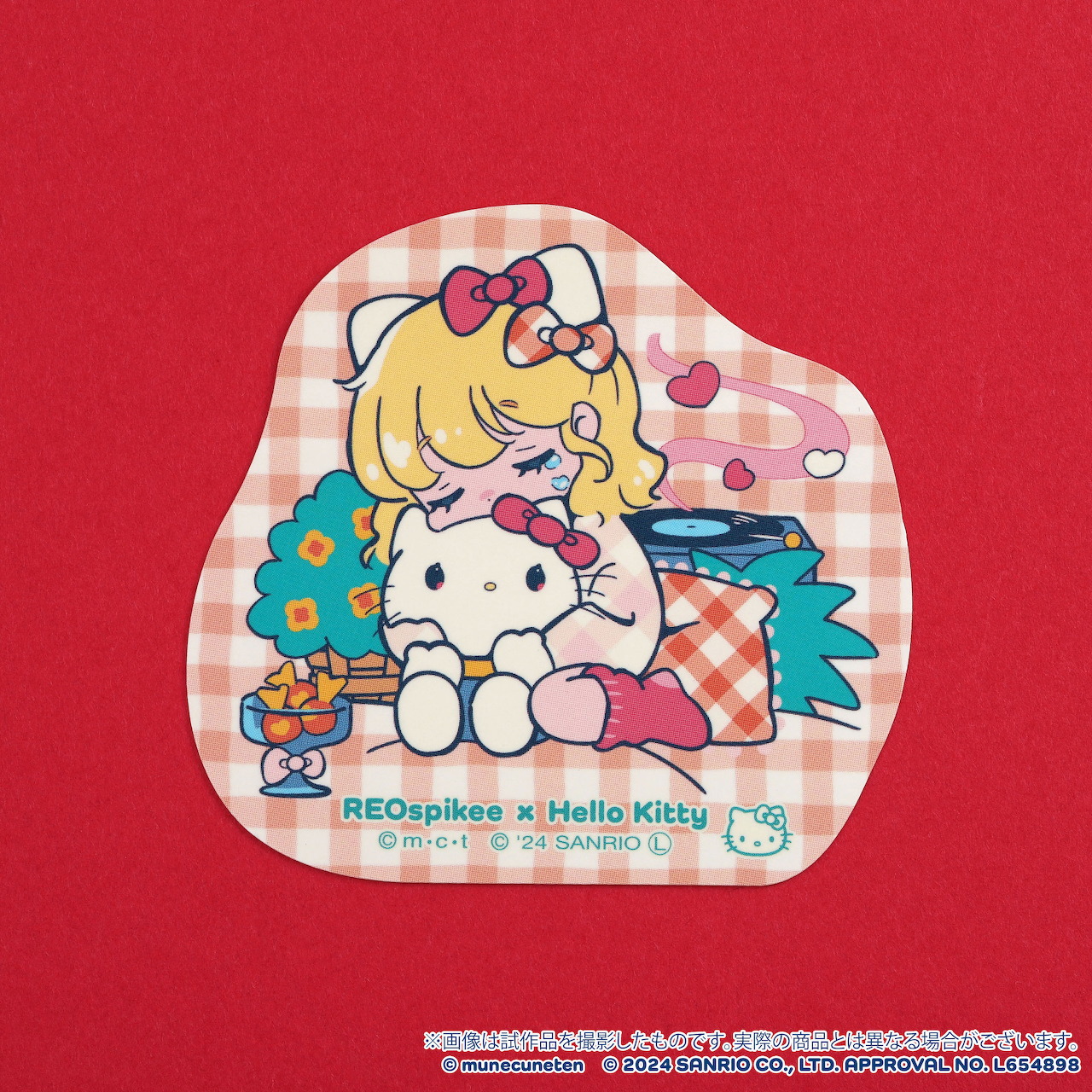 Hello Kitty sticker with blonde girl character on pink gingham background with hearts and flowers