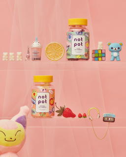 Pastel pink illustration with cute jars, a cupcake, lemon slice, toy bear, strawberries, headphones, and plush toy