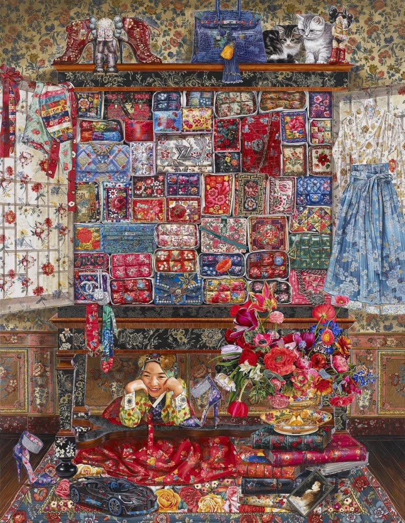 Wooden cabinet displaying colorful vintage quilts, patchwork textiles, and decorative objects on shelves