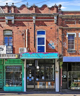 Red brick Victorian building with turquoise awning and decorative roofline housing Konak Indian Restaurant