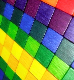 Colorful wooden blocks arranged in a rainbow checkered pattern