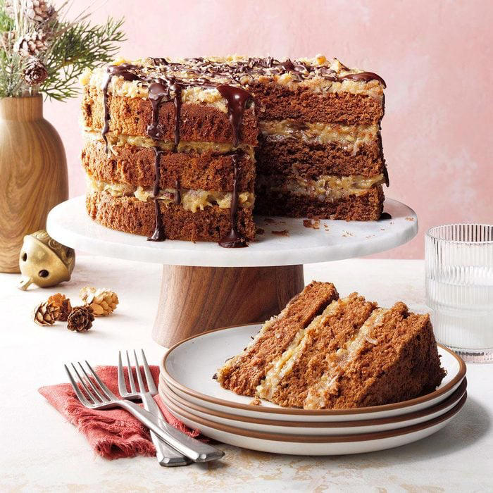 Layered German chocolate cake with coconut pecan frosting, slice served on white plates
