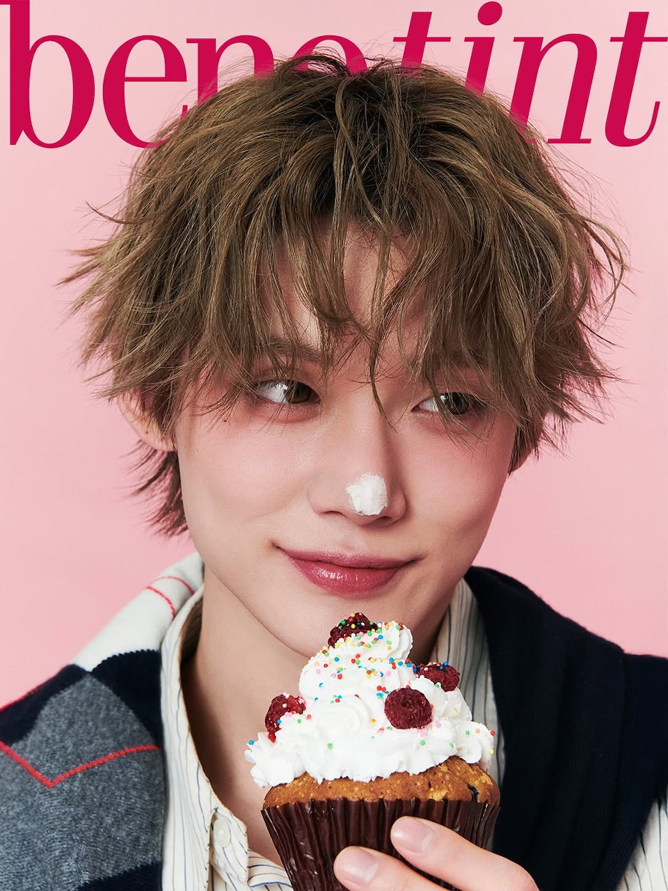 Young man with brown hair holding a raspberry cupcake on a pink background, Benetint magazine cover