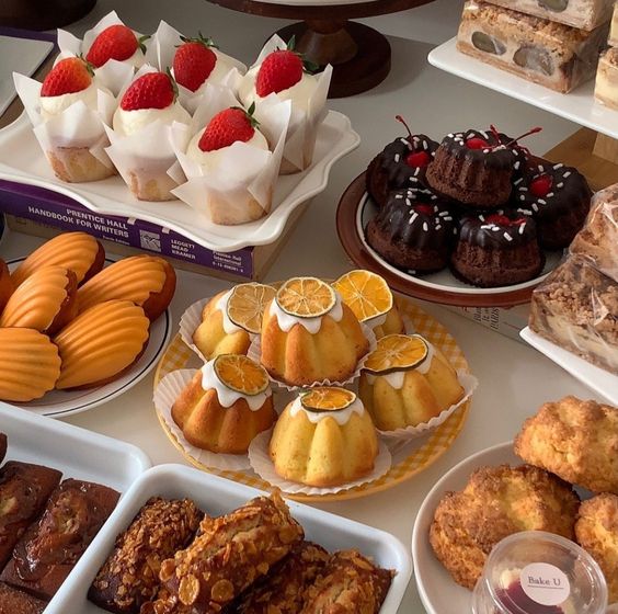 Variety of desserts on plates: strawberry cakes, chocolate cake, puddings, cream puffs, and cookies