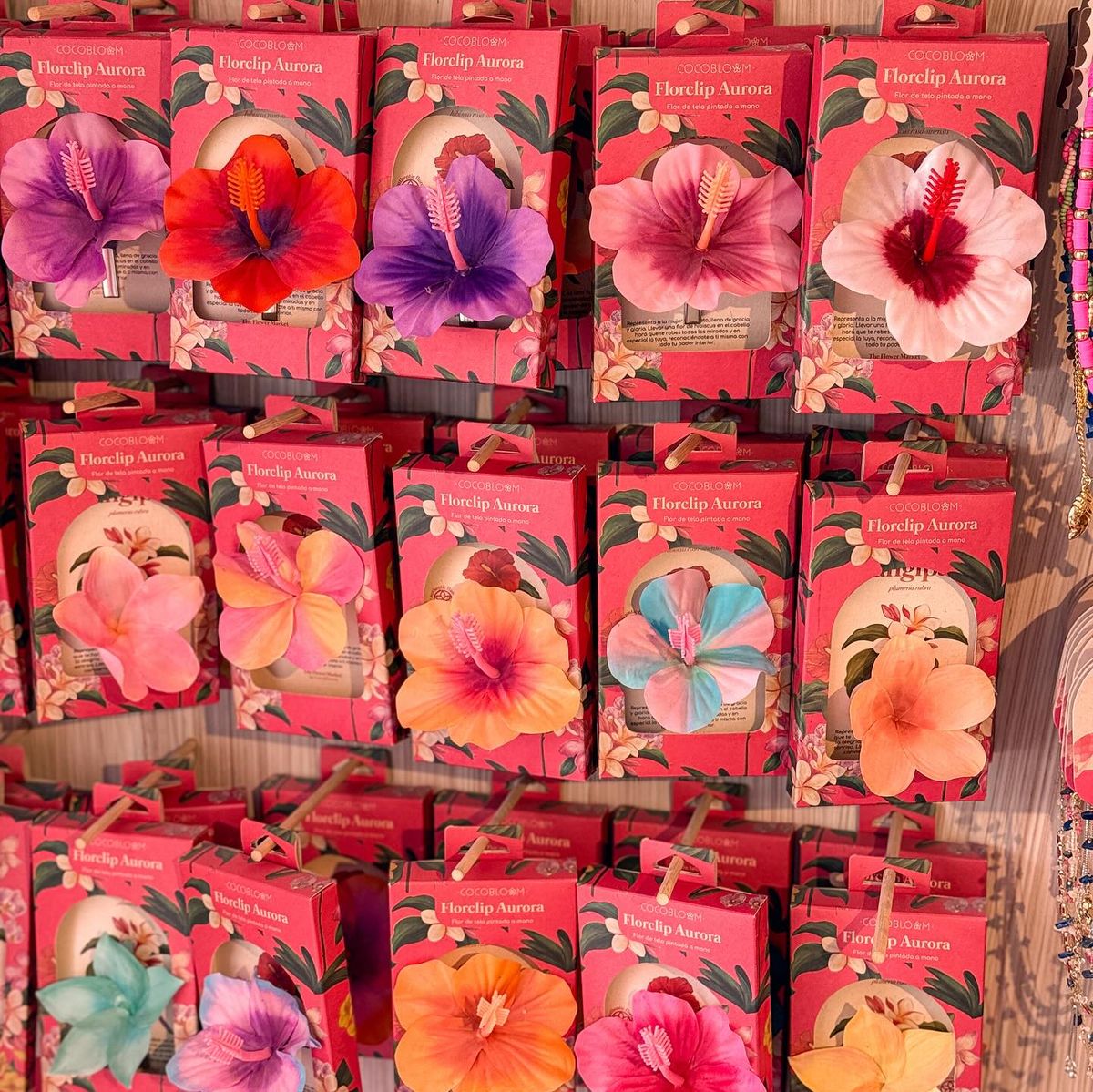 Display rack of colorful tropical flower packets with large hibiscus-style blooms