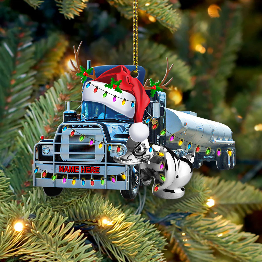 Toy tanker truck ornament hanging on a Christmas tree branch with holiday lights