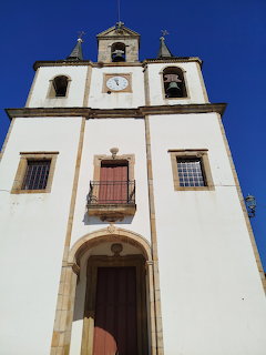 Facade of Iglesia de Santa Marina church with twin bell towers and clock, Puerto de Vega, Asturias