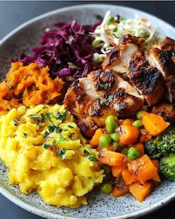 Plate with grilled chicken, mashed potatoes, purple cabbage, coleslaw, broccoli, peas and carrots