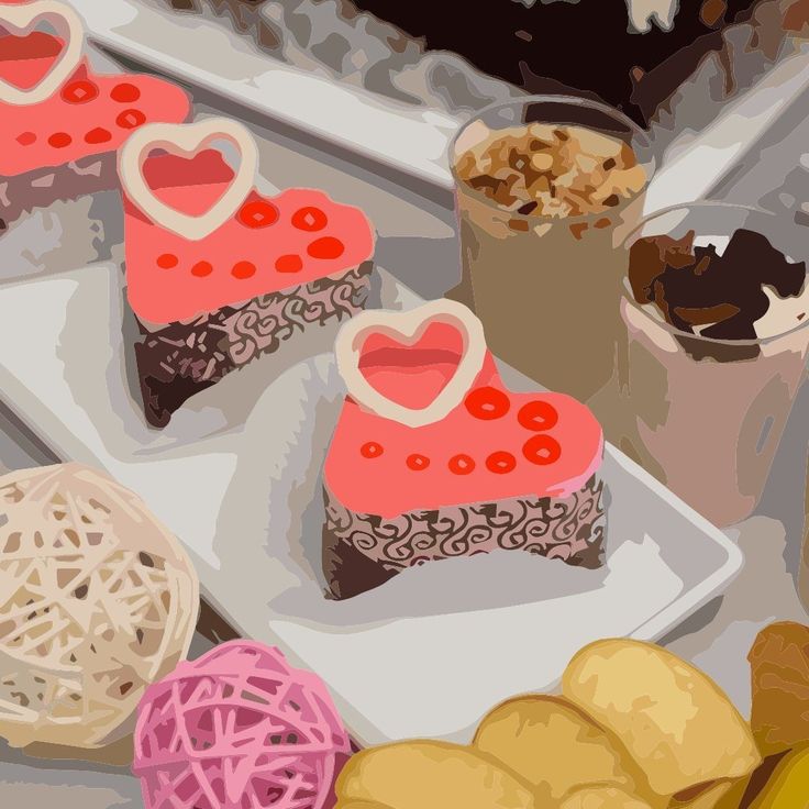 Pink heart-topped cake slices with dessert cups and pastries on display trays