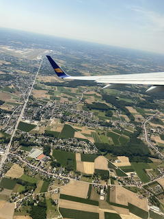 View of clouds and sky seen from an airplane window mid-flight