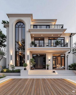 Modern white luxury villa with arched window, balconies, and wooden deck at twilight