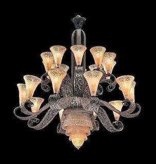 Ornate vintage chandelier with crystal shades and scrolled metal arms on black background