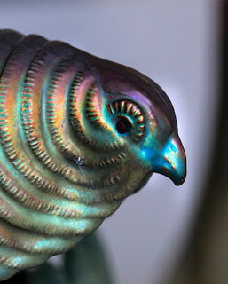 Iridescent ceramic bird with rainbow metallic glaze in turquoise and purple tones