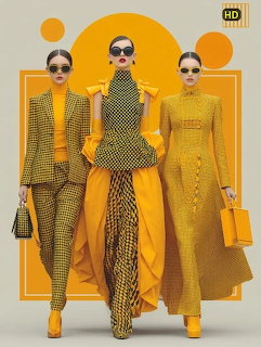 Three fashion models wearing yellow and gold designer outfits against an orange geometric background