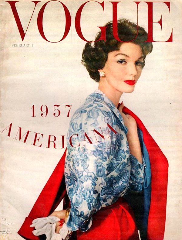 1957 Vogue magazine cover showing woman in blue lace jacket and red dress