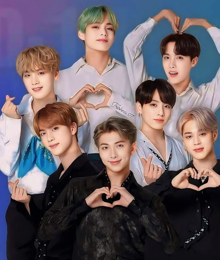 Group portrait of seven young men in casual and formal wear making peace signs and heart shapes