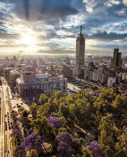 Aerial view of Alameda Central, Bellas Artes, and Torre Latinoamericana at sunset in Mexico City.