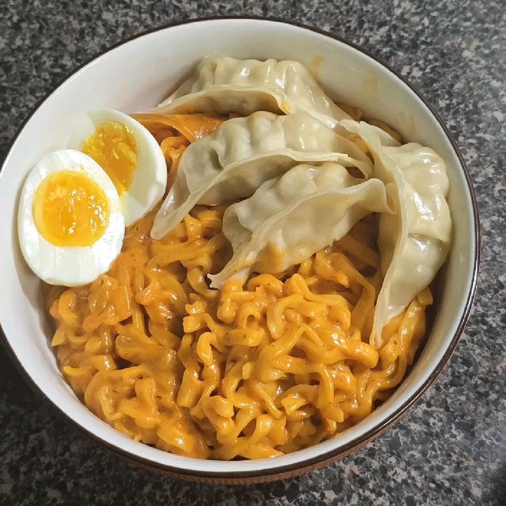 Bowl of ramen noodles with dumplings and soft-boiled egg