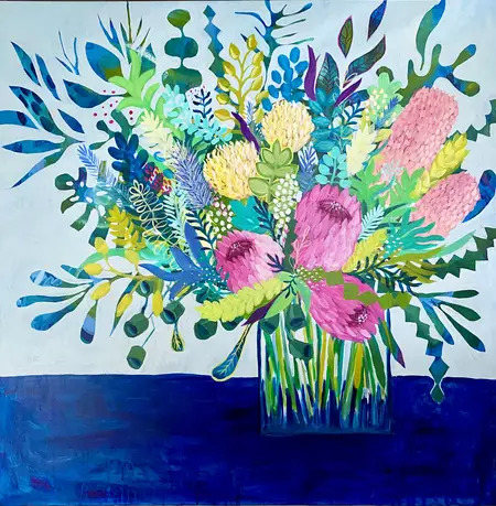 Colorful painted flower bouquet in a glass vase on a blue table