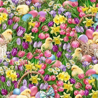 Yellow chicks among Easter eggs, daffodils, tulips and crocuses in a spring garden
