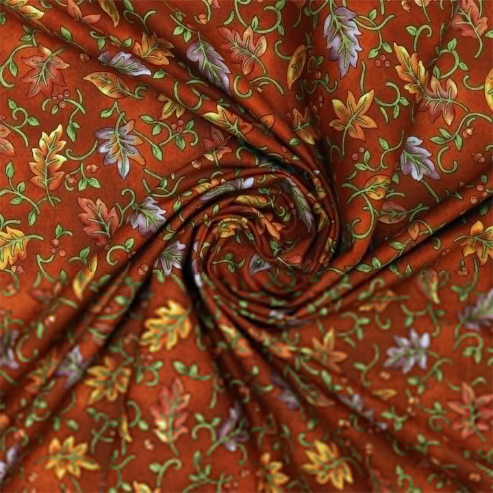 Close-up of red floral fabric twisted into a spiral pattern