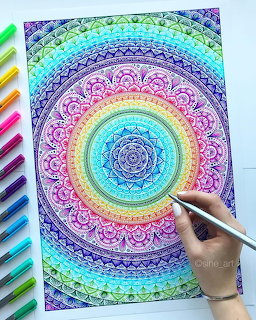 Hand drawing colorful rainbow mandala with intricate geometric patterns and concentric circles