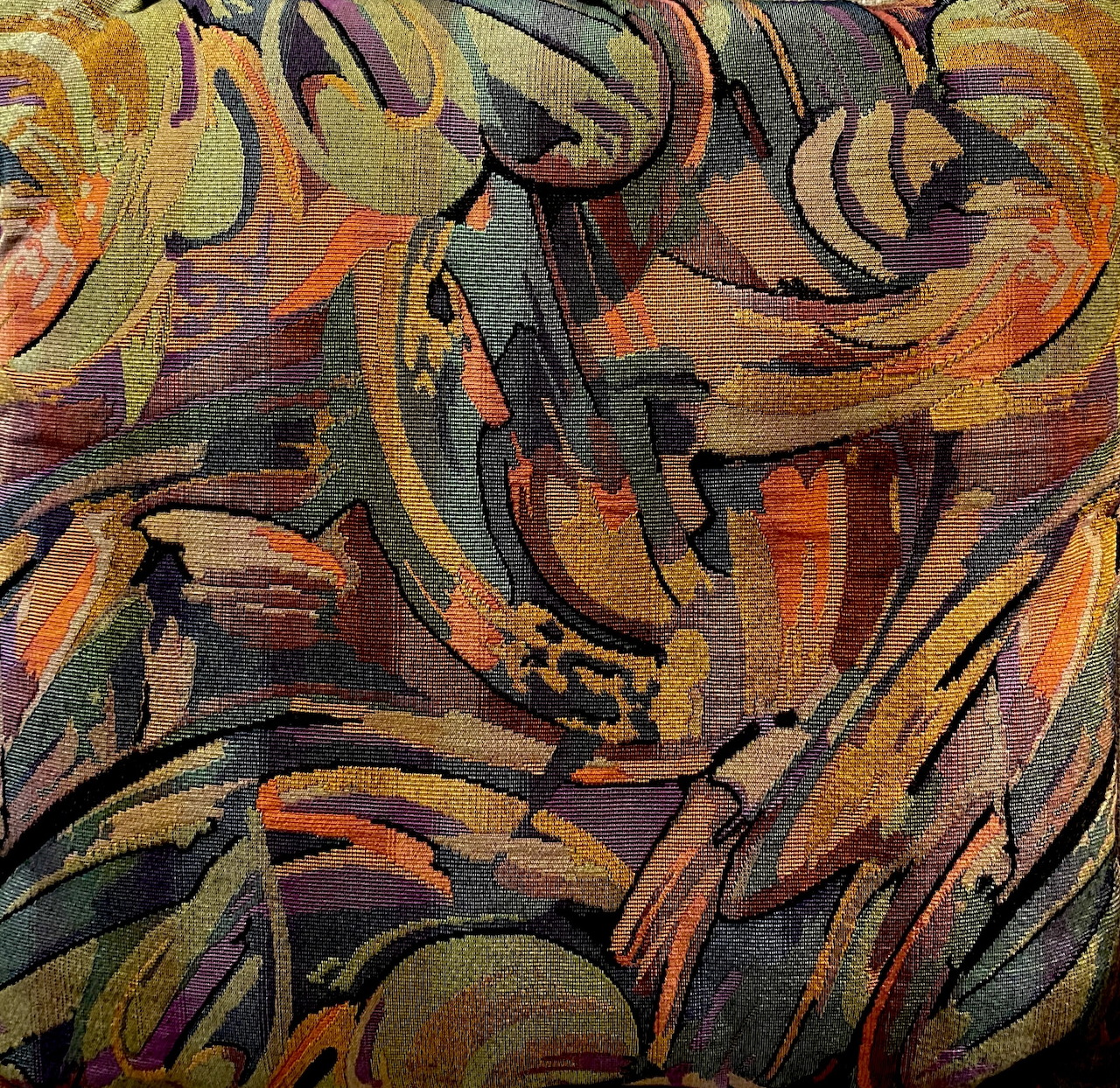 Close-up of a colorful abstract pillow or fabric pattern with swirling shapes
