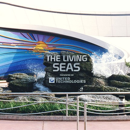 The Living Seas pavilion entrance at Epcot with blue wave mural and signage
