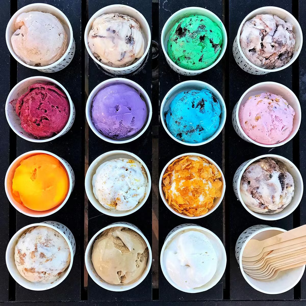 Grid of 16 ice cream containers in various colors viewed from above
