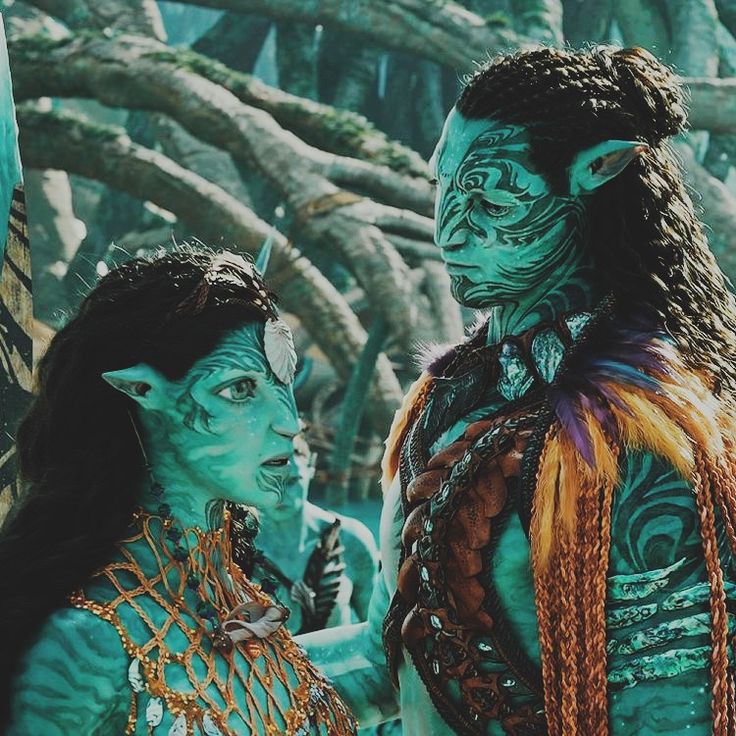 Blue-skinned couple in elaborate traditional Indian attire and jewelry facing each other