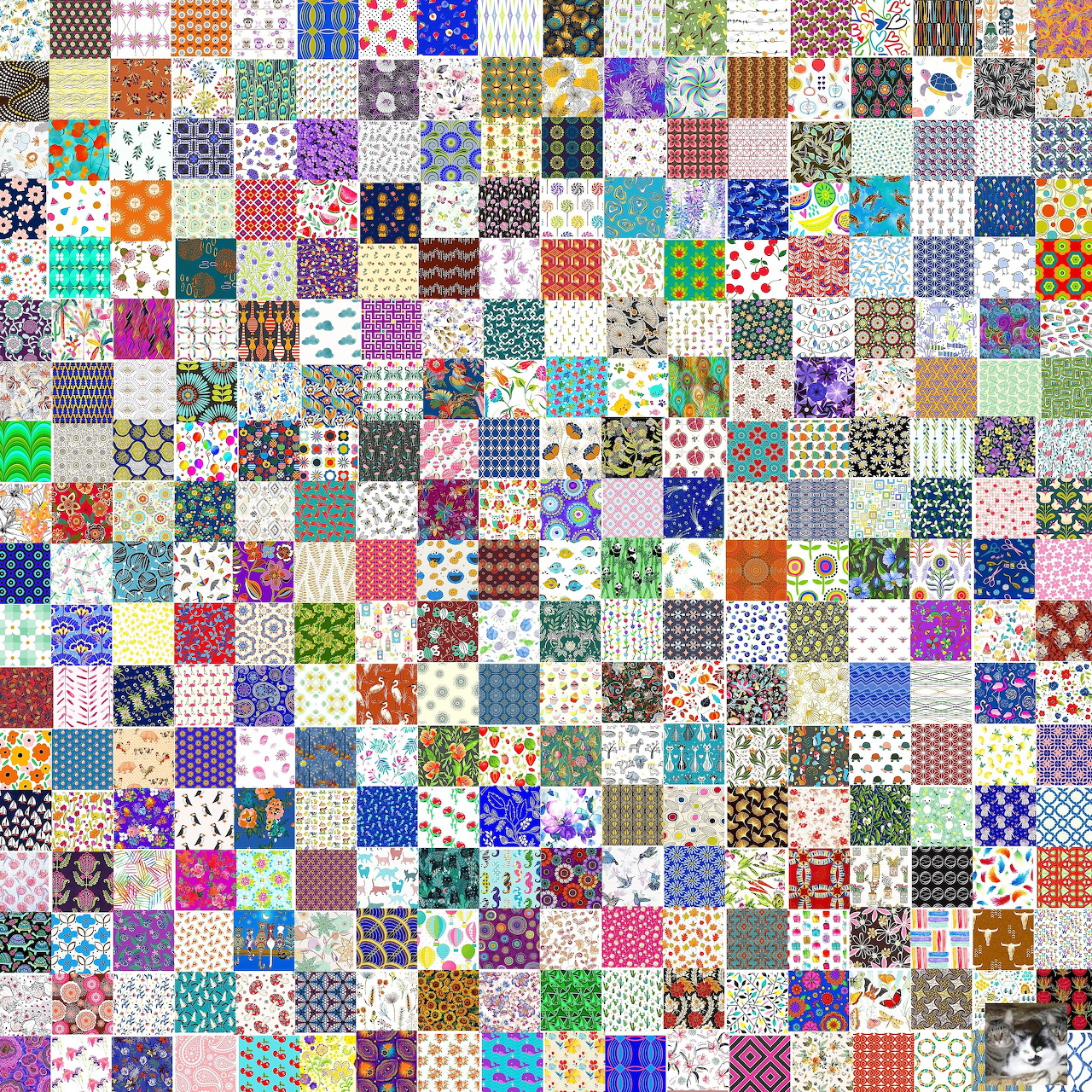 Colorful patchwork quilt with hundreds of small fabric squares in various patterns and colors arranged in a checkerboard grid